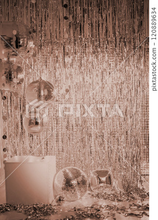 Shiny disco balls and foil fringe curtain indoors, toned in mocha colors Shiny disco balls and foil fringe curtain indoors, toned in mocha colors 120889634