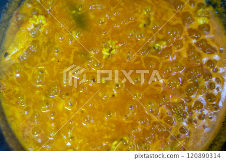 Top view of the cooking process of rice for a typical Spanish seafood paella, traditional healthy food. Mediterranean diet concept Top view of the cooking process of rice for a typical Spanish seafood paella, traditional healthy food. Mediterranean diet concept 120890314