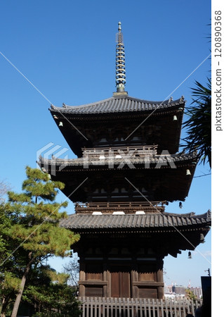 Triple tower that shines in the blue sky 120890368