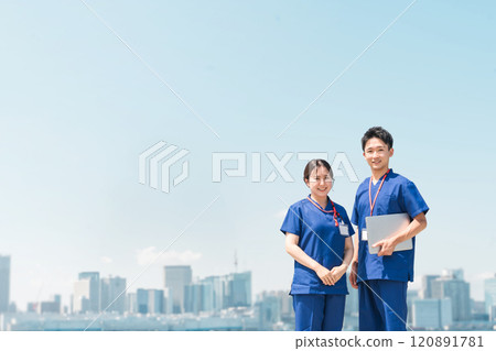 Doctors, nurses, medical staff, occupational therapists, and physical therapists in scrubs under a blue sky 120891781