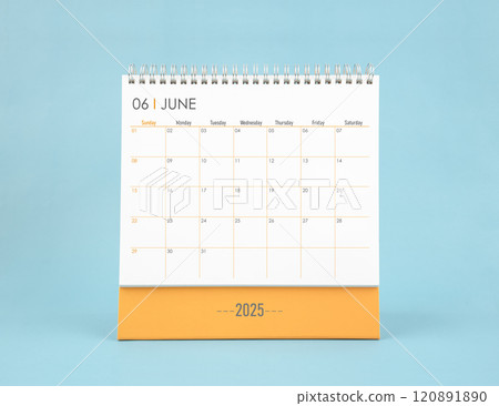 June 2025 white desk calendar on blue color background. 120891890