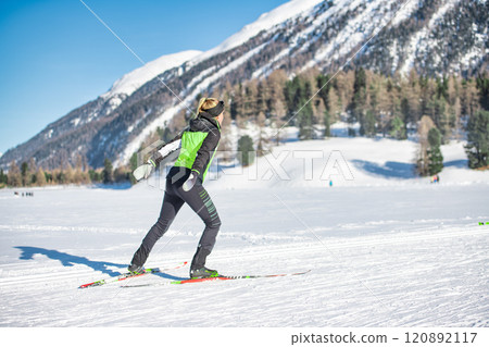 Woman practices cross-country skiing with free technique without poles Woman practices cross-country skiing with free technique without poles 120892117