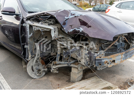 A passenger car is parked in the parking lot with damage to the right front part as a result of an accident. A passenger car is parked in the parking lot with damage to the right front part as a result of an accident. 120892572