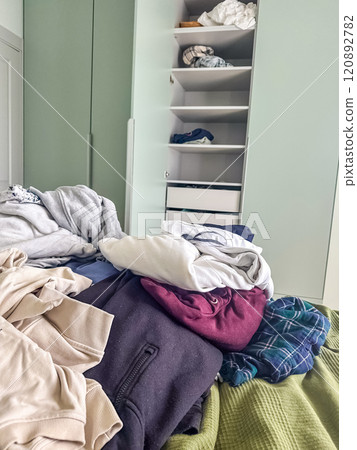 Messy Wardrobe and Pile of Clothes on the Bed. High quality photo Messy Wardrobe and Pile of Clothes on the Bed. High quality photo 120892782