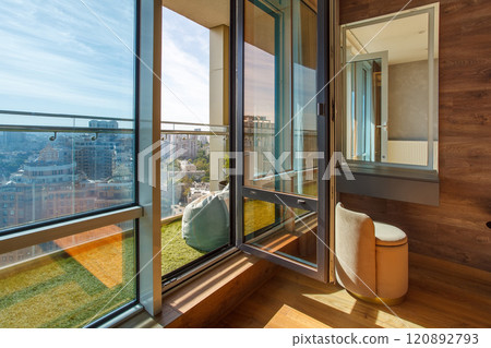 Panoramic view from the balcony with artificial grass and glass railing. 120892793