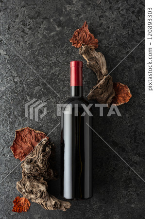 Bottle of red wine on a black stone background. Bottle of red wine on a black stone background. 120893303