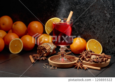 Mulled wine with ingredients on a black kitchen table. 120893322