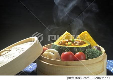 Steaming the stuffed pumpkin in a steamer 120894335