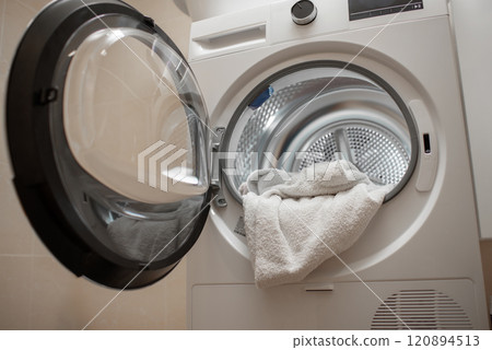 Inside of tumble dryer with clean white towels - new generation of dryer, household concept Inside of tumble dryer with clean white towels - new generation of dryer, household concept 120894513