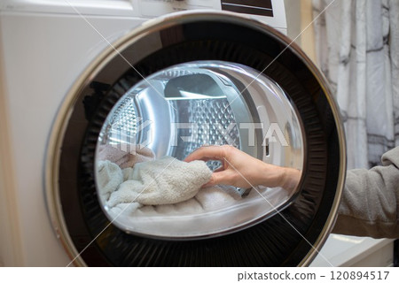 Inside of tumble dryer with clean white towels - new generation of dryer, household concept 120894517