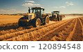 Cultivation of the field by tractors after harvesting. 120894548