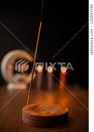 Incense sticks smoldering on table indoors, space for text Incense sticks smoldering on table indoors, space for text 120895398