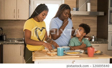 African American family enjoying breakfast in kitchen at home 120895640