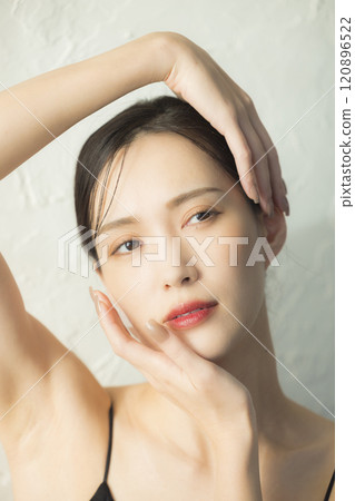 Young woman holding her hands to her face Young woman holding her hands to her face 120896522