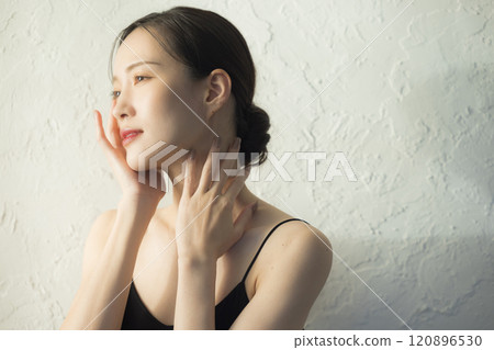 Young woman holding her hands to her face 120896530