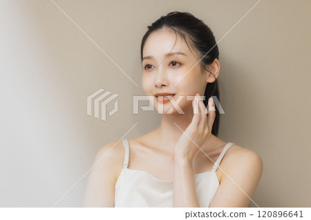 Woman smiling with hands on face 120896641