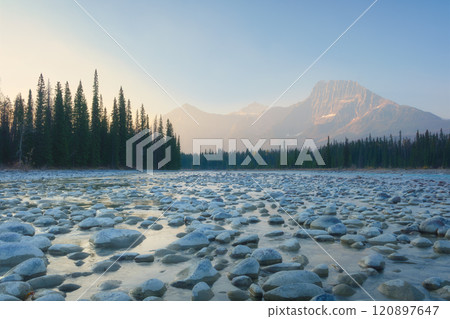 Mountain landscape at the morning. River coast with stones and forest in a mountain valley Mountain landscape at the morning. River coast with stones and forest in a mountain valley 120897647