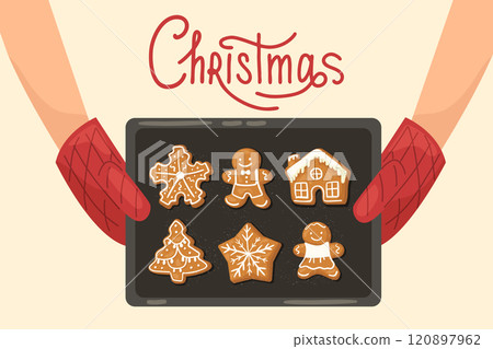Hands in oven mitts holding a baking tray with hot gingerbread Christmas cookies. Christmas text 120897962