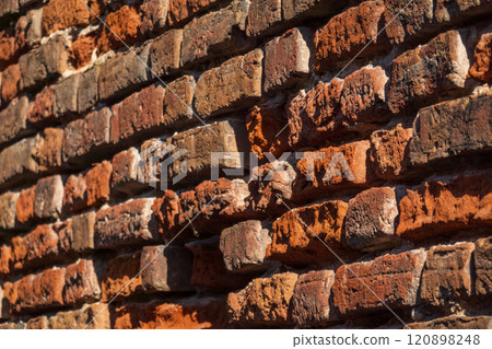 Close-up of rustic weathered brick wall with rich textures and colors Close-up of rustic weathered brick wall with rich textures and colors 120898248