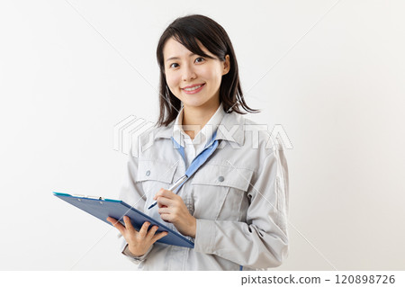Smiling woman in work clothes taking notes 02 Smiling woman in work clothes taking notes 02 120898726