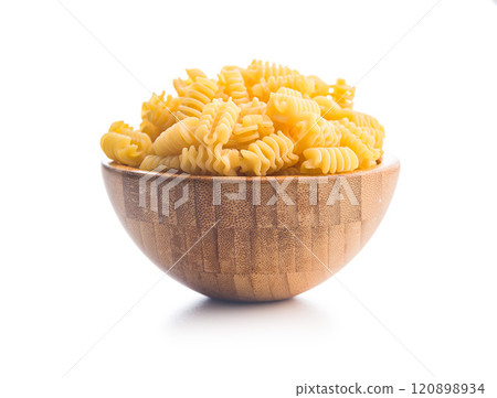 Uncooked italian pasta. Radiatori pasta in bowl isolated on white background. 120898934