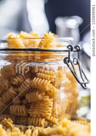 Uncooked italian pasta. Radiatori pasta in jar. 120898961