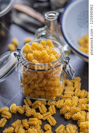 Uncooked italian pasta. Radiatori pasta in jar. Uncooked italian pasta. Radiatori pasta in jar. 120898962