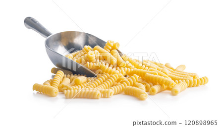 Uncooked italian pasta. Fusilli pasta in scoop isolated on white background. 120898965