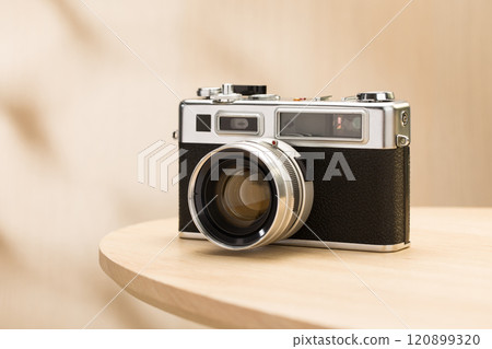 A classic rangefinder film camera sits elegantly. 120899320