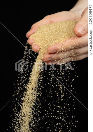 Hands pour crystalline cane brown unrefined healthy demerara sugar Hands pour crystalline cane brown unrefined healthy demerara sugar 120899473