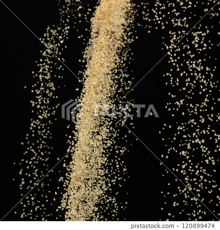Macro Cane Brown Sugar Flow on Black Background 120899474