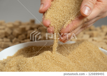 Hands pour crystalline cane brown unrefined healthy demerara sugar 120899491