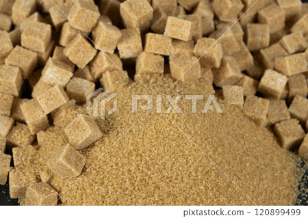 Brown cane unrefined demerara sugar in the form of crystals and cubes Brown cane unrefined demerara sugar in the form of crystals and cubes 120899499