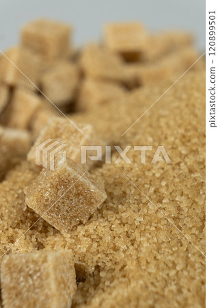 Brown cane unrefined demerara sugar in the form of crystals and cubes Brown cane unrefined demerara sugar in the form of crystals and cubes 120899501