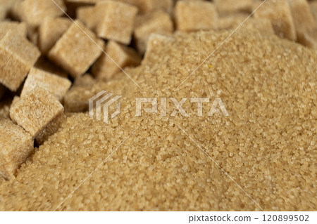 Brown cane unrefined demerara sugar in the form of crystals and cubes Brown cane unrefined demerara sugar in the form of crystals and cubes 120899502