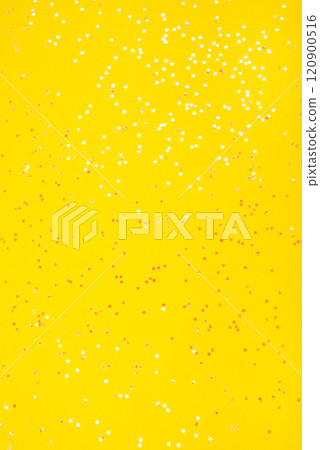 Tiny pearl stars on yellow background. 120900516