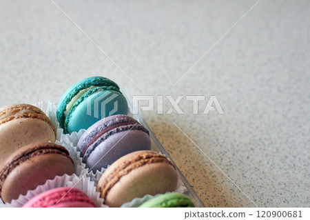 Bright colorful cakes French Macarons with white paperpan in plastic box Bright colorful cakes French Macarons with white paperpan in plastic box 120900681