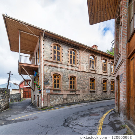 Traditional stone bricks building with a wooden balcony, located on a narrow street in Sheki, Azerbaijan Traditional stone bricks building with a wooden balcony, located on a narrow street in Sheki, Azerbaijan 120900998