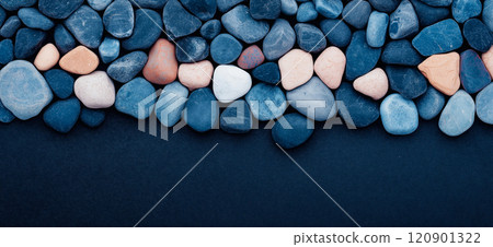 Polished opal pebble background. Smooth round colorful gravel stone texture 120901322