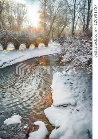 Outstanding winter sunset in city park with trees in the snow. Outstanding winter sunset in city park with trees in the snow. 120901757