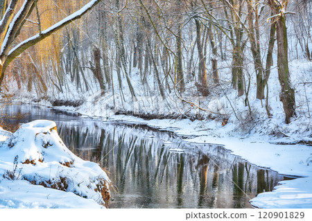 Outstanding landscape in city park with snowy trees and beautiful reflection in frozen river. Outstanding landscape in city park with snowy trees and beautiful reflection in frozen river. 120901829