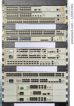Network switches and routers stacked in a data center view showcasing connectivity technology 120901981