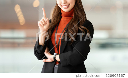 A woman/businesswoman pointing with her index finger up A woman/businesswoman pointing with her index finger up 120902167