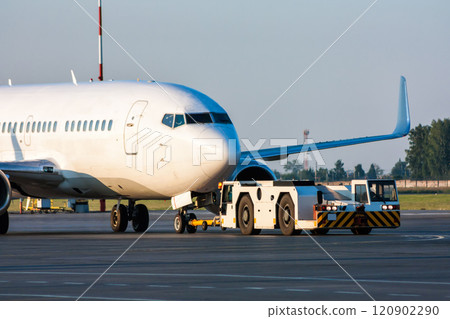 The truck is towing the passenger aircraft The truck is towing the passenger aircraft 120902290
