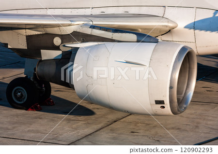 Close-up of engine and main landing gear of passenger aircraft 120902293
