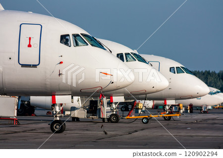 Close-up passenger airplane noses in line at the parking lot of airport 120902294