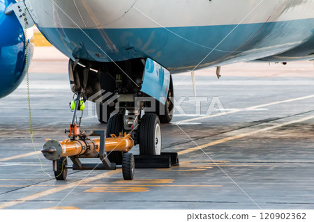 Towbar attached to the front landing gear of the airplane Towbar attached to the front landing gear of the airplane 120902362