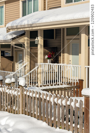 Small front yard, porch and entrance of residential townhouses on winter season in Canada 120902483