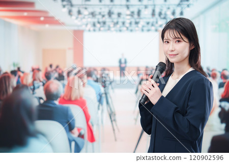 A female reporter asking a question at a press conference A female reporter asking a question at a press conference 120902596