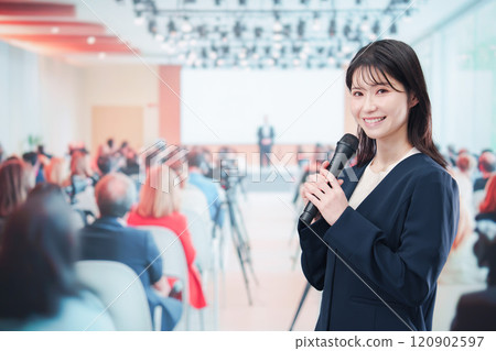 A female reporter asking a question at a press conference A female reporter asking a question at a press conference 120902597